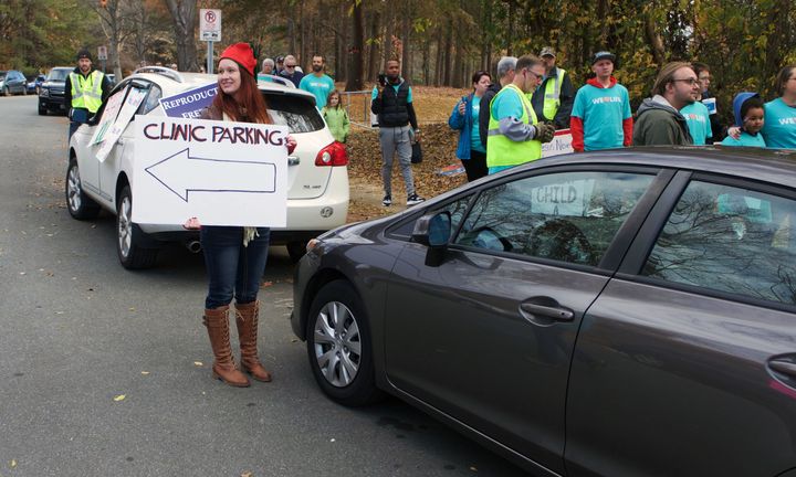 One member of Pro-Choice Charlotte directs traffic outside of APWHC in December 2016. 