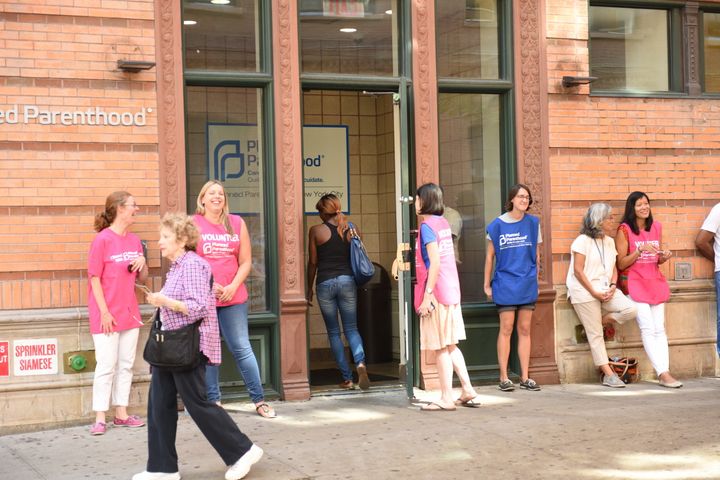 Volunteer clinic escorts stand outside Planned Parenthood NYC in August 2015. 