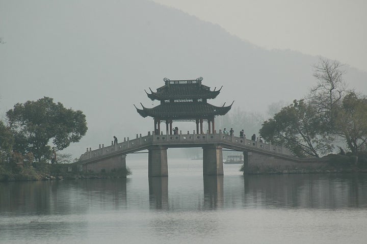 A bridge adds to the picturesque quality of West Lake, Hangzhou, China, as charming as it was in Marco Polo’s day.