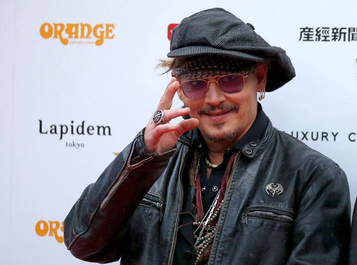 Johnny Depp poses on the red carpet at the 2016 Classic Rock Roll of Honour Awards.