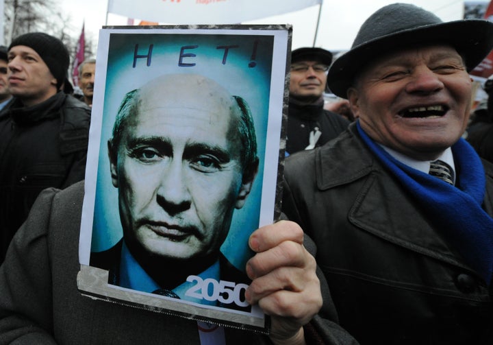 Opposition activists rally at the Bolotnaya Square in central Moscow, on Dec. 10, 2011. The poster depicts Putin looking old and reads: "2050 - No!"