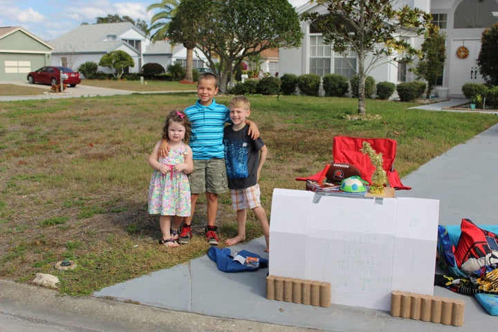 Two children came by to give Blake more toys for his stand.