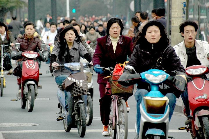 <p> <em>Braving the traffic: bikes and mopeds cram their lane on the streets of Hangzhou</em></p>