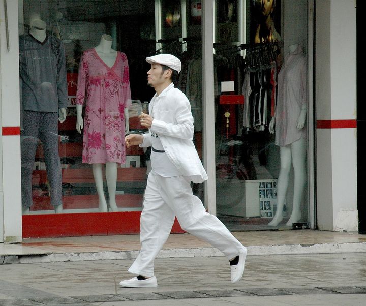 <p><em>A fashionable man struts down Wulin Road, Hangzhou’s ‘Fashion Avenue.’ The city manifests old & new </em></p>