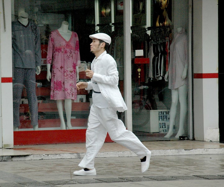 A fashionable man struts down Wulin Road, Hangzhou’s ‘Fashion Avenue.’ The city manifests old & new 