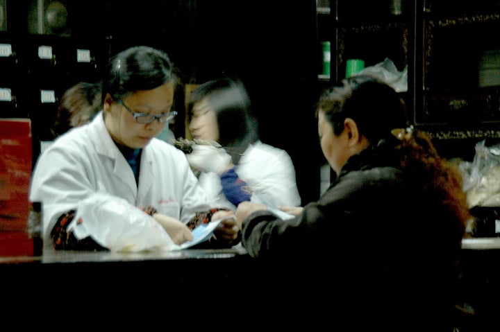 Pharmacists at the Hu Qingyutang Chinese Pharmacy founded in 1874 by Hu Xueyan