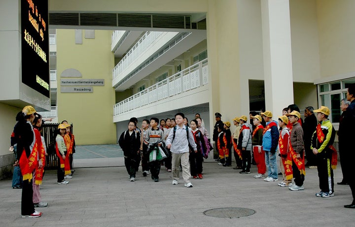 School children on their way home after being dismissed for the day from the Anji Road Experimental School, built in 1954