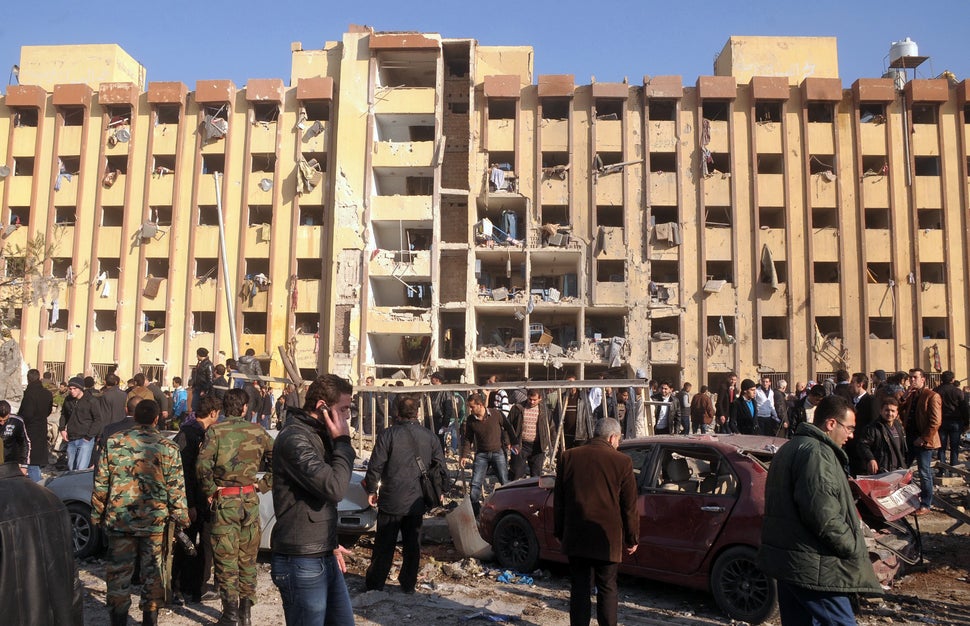 Syrian's gather at the scene of an explosion outside Aleppo university, between the university dormitories and the architectu