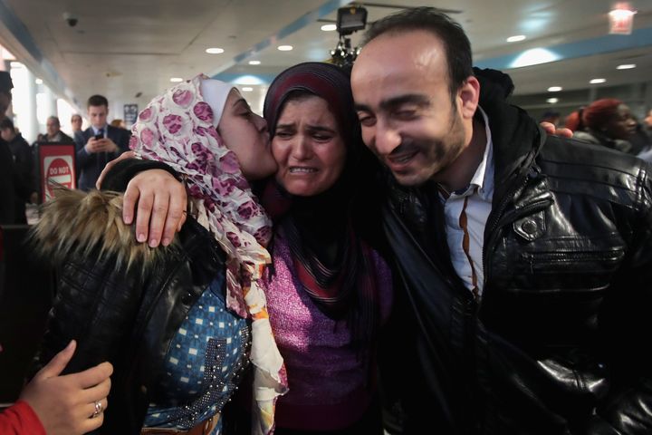 Syrian refugee Baraa Hajj Khalaf, left, and her husband, Abulmajeed, are greeted by her mother, Fattuom, after a second-attempt flight from Turkey to Chicago on Feb. 7.