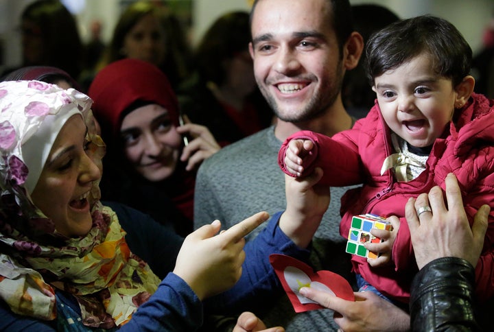 Baraa Hajj Khalaf's daughter, Sham, gets to meet her relatives, including Uncle Mohamad, right, after a news conference at O'Hare airport.