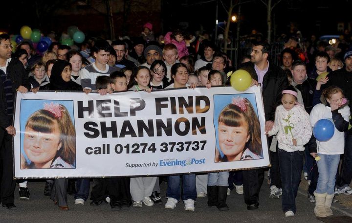 Supporters and family members of missing nine year old Shannon Matthews walk around Dewsbury