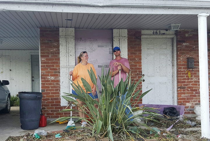 Sharon Walter and her son, Daniel Wilson, clean up debris outside Walter's mother's house.