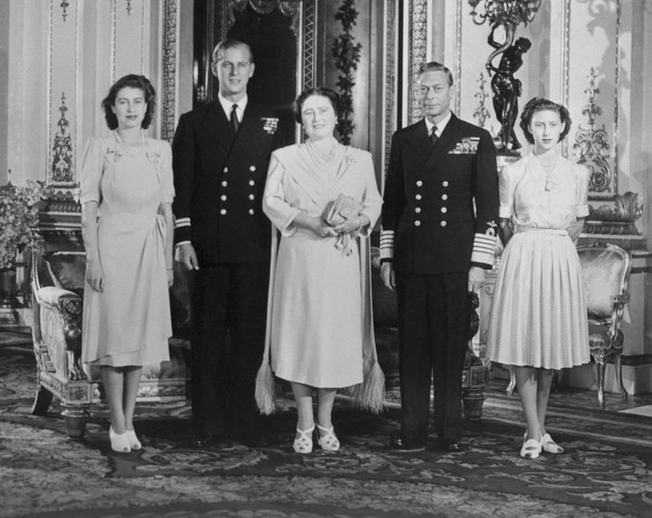 Then-Princess Elizabeth, Philip, then-Queen Elizabeth, King George VI and Princess Margaret Rose in the White Drawing Room of Buckingham Palace.