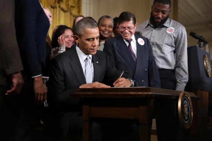 Chiliquinga, standing to Obama's left as he signed the $10.10 executive order.