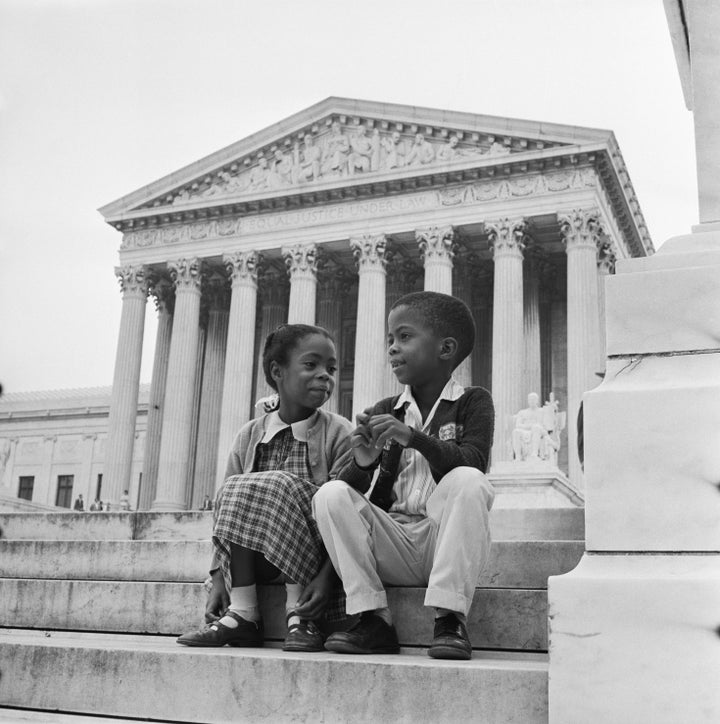 Children sit in front of the Supreme Court, which was hearing arguments about the integration of Little Rock schools.