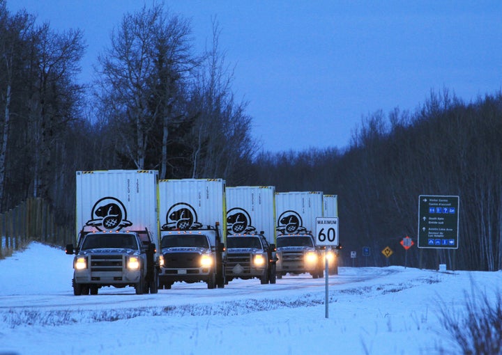 Trucks loaded with custom shipping containers full of bison leave Elk Island National Park for the 250-mile trip to the staging area at the Ya Ha Tinda ranch just outside the Banff National Park in Alberta, Canada, on Jan. 31.