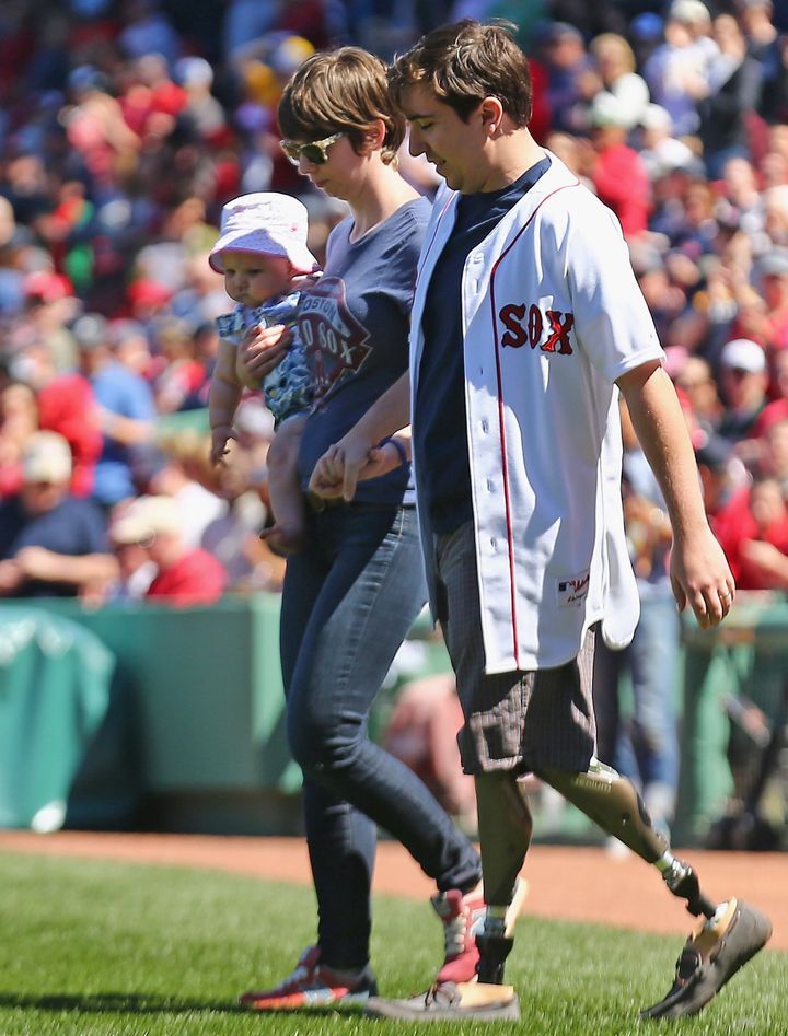 The couple and their daughter at Fenway Park on April 15, 2015, two years after the attack.