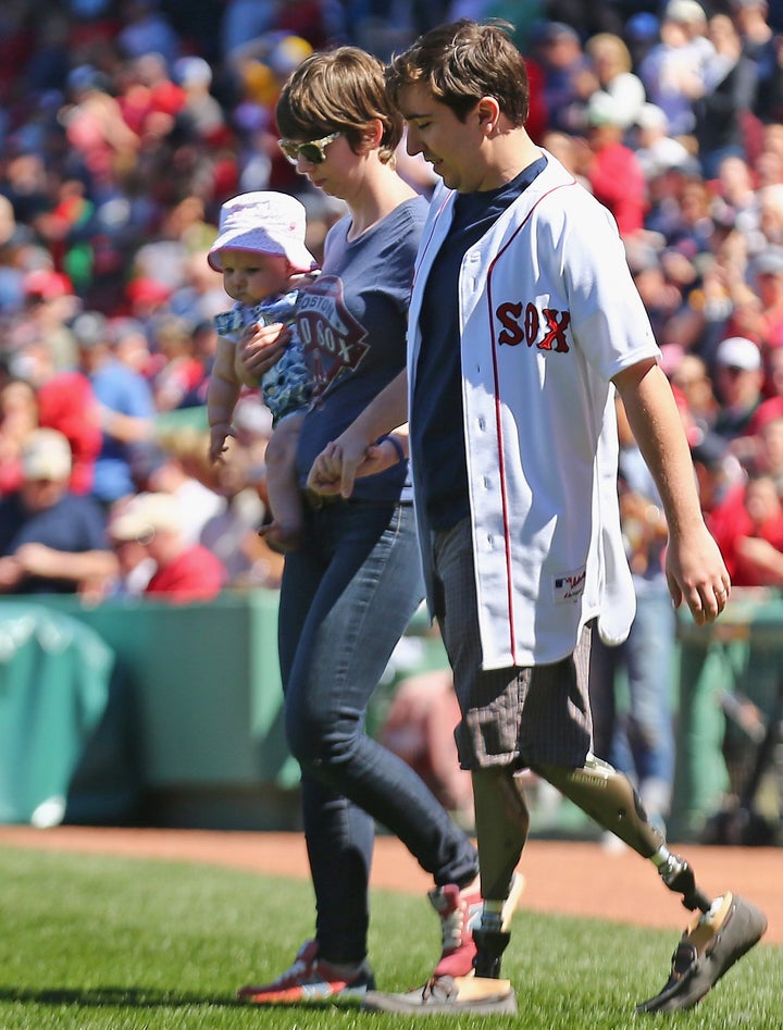 The couple and their daughter at Fenway Park on April 15, 2015, two years after the attack.