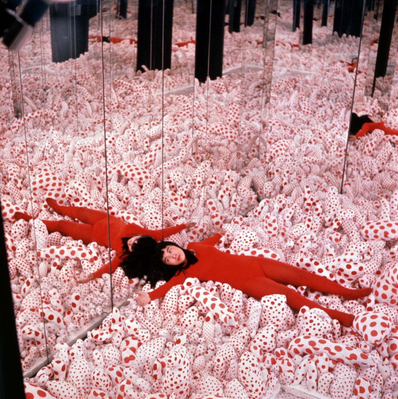 Yayoi Kusama posing in "Infinity Mirror Room—Phalli’s Field,"1965.