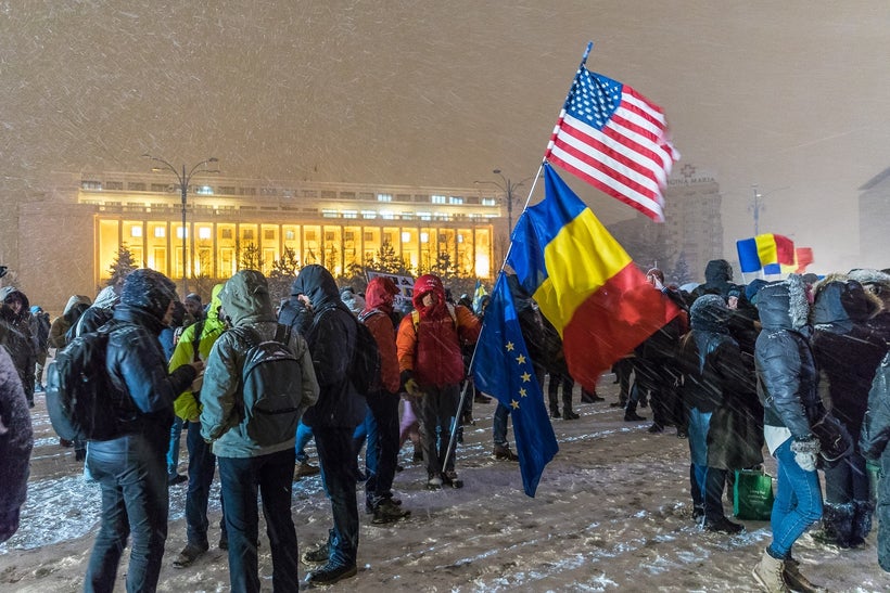 Protesters gather in front of the government building in Victory Square, Bucharest, Romania.
