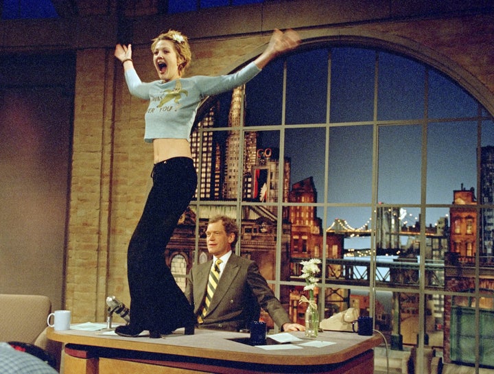 Drew Barrymore stands atop David Letterman's desk on an infamous 1995 "Late Show" episode.