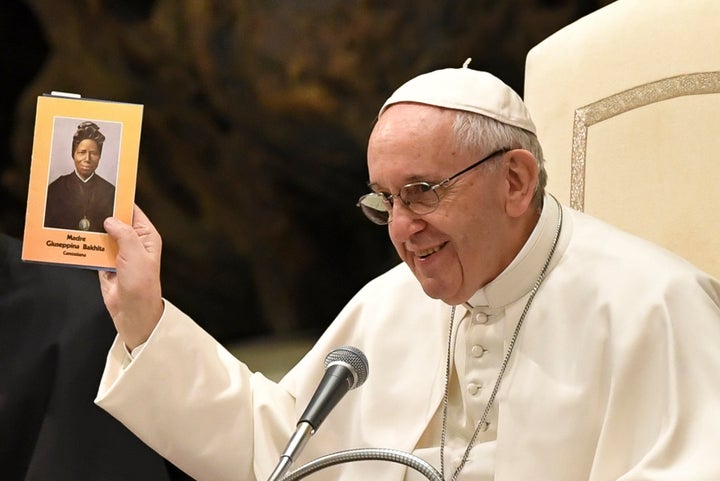 Pope Francis holds up an icon of Sudanese saint Josephine Bakhita during a general audience at the Paul VI Audience Hall at t