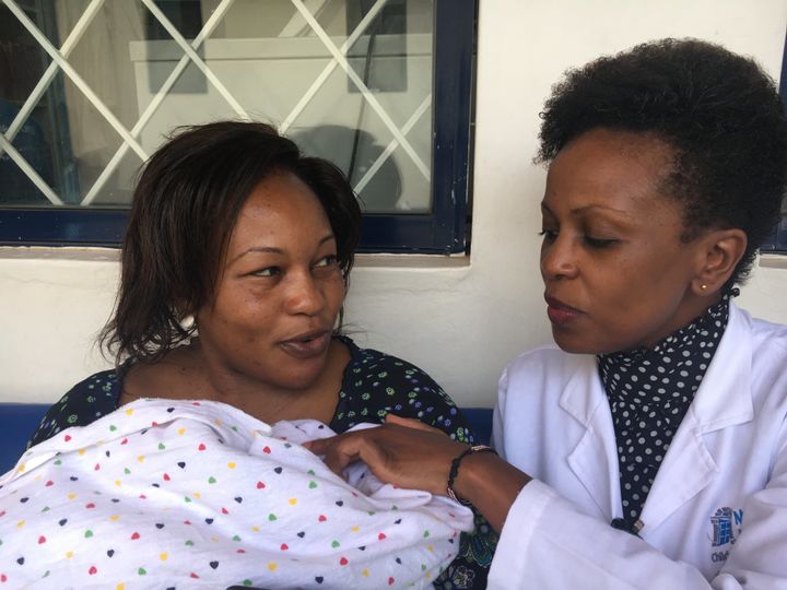 Obstetrician and gynaecologist Carolyne Nduhiu speaks to a new mother at the Marie Stopes clinic in Eastleigh, one of Nairobi's poorest neighborhoods.