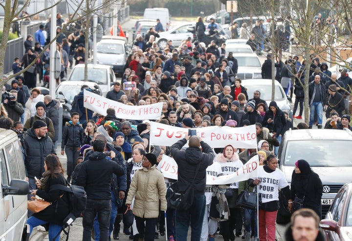 People hold signs reading "Justice for Theo" during a protest on Feb. 6, 2017, in Aulnay-sous-Bois, northern Paris.