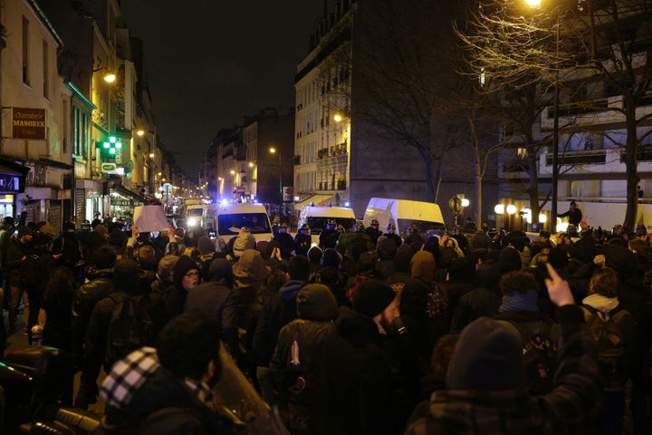 Police block a street as people gather to protest against an alleged police assault on a black man in central Paris, Feb. 8, 2017.