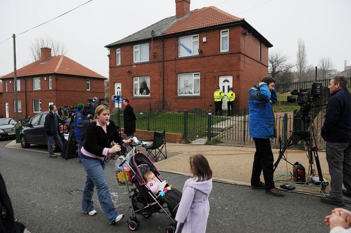 Police officers guard the home of Shannon and Karen Matthews during the search for the nine-year-old in 2008 