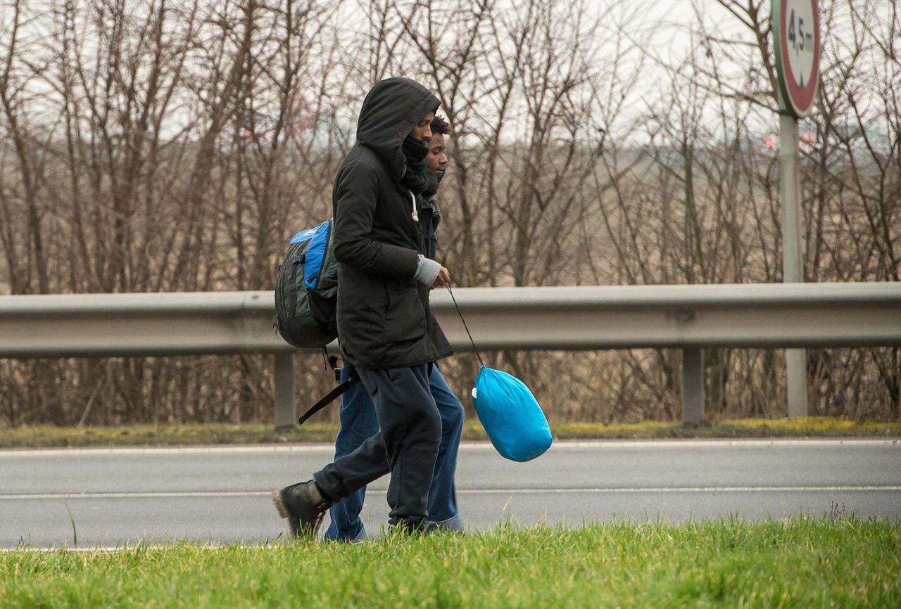 As many as 50 unaccompanied refugee children have begun arriving this week in Calais, northern France, alongside adults. This photo shows migrants walking along a road leading to Calais this week