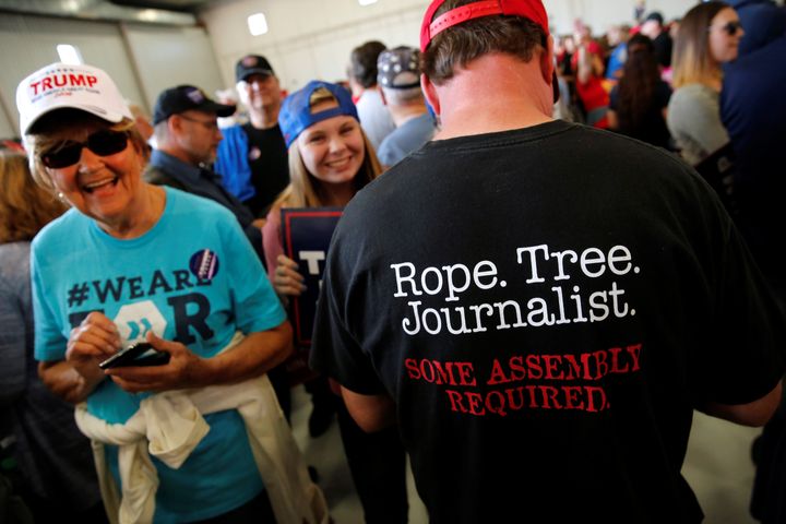 A man wears a shirt reading "Rope. Tree. Journalist." at a Trump rally in Minnesota