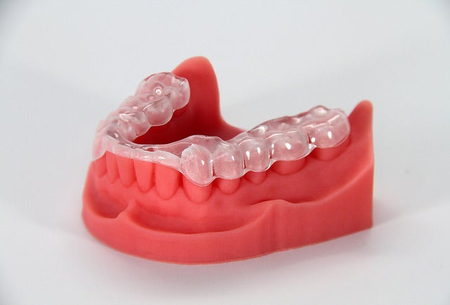 This dental model and night guard were 3D printed. It takes less time and money to custom manufacture dental prosthetics and orthodontic appliances with 3D printing than traditional methods.