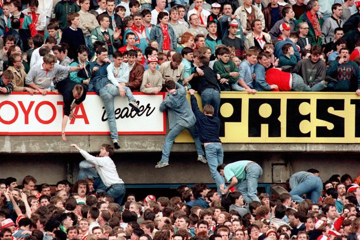 Fans are pulled into the upper tier of the Leppings Lane end during the Hillsborough Disaster in 1989