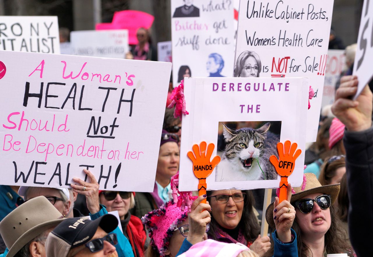 Planned Parenthood supporters hold signs at a protest in downtown Denver, Colorado, U.S. February 11, 2017.