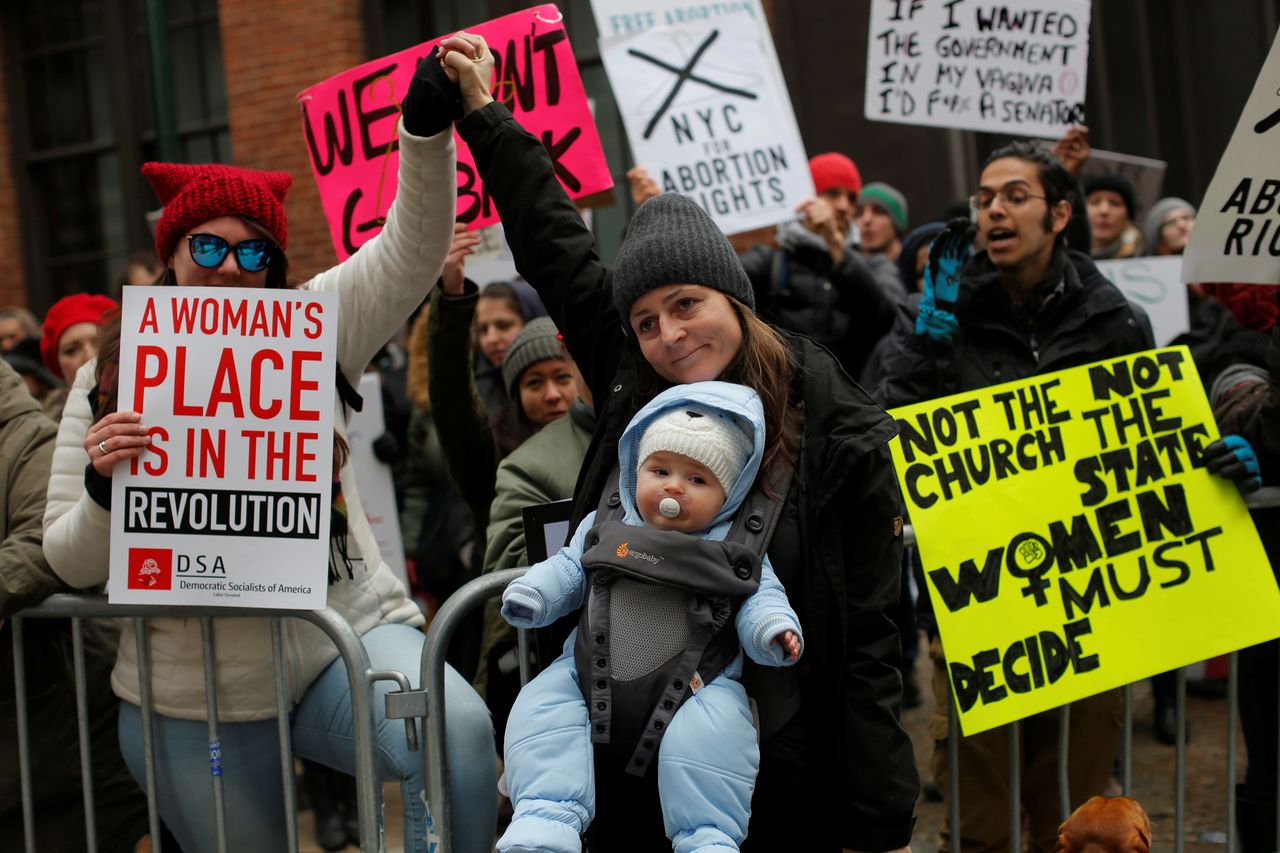Valentina Vassilev and her son Ethan Vassilev of New York greet a group of pro-choice protesters gathered to counter an anti-Planned Parenthood vigil outside the Planned Parenthood - Margaret Sanger Health Center in Manhattan, New York, U.S., February 11, 2017.