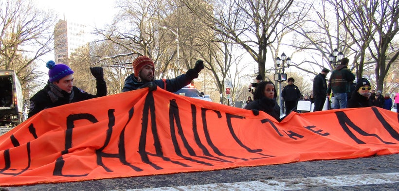 Protesters block the intersection in front of Calhoun College at Yale on Friday during rush hour. The university announced th