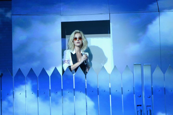 Katy behind her white picket fence