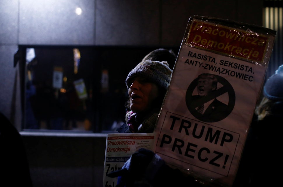 A woman holds a placard saying "Trump Away!" as people&nbsp;gather to protest against U.S. President Donald Trump in front of