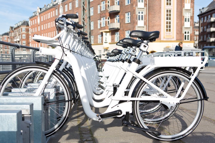 Electric bikes parked in charging docks available across the city through Copenhagen’s bikeshare program