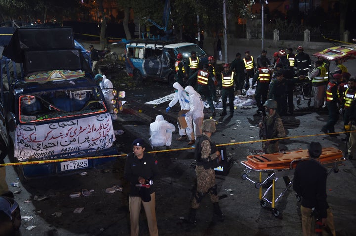 Pakistani security officials inspect the site after a powerful explosion in Lahore on February 13, 2017.