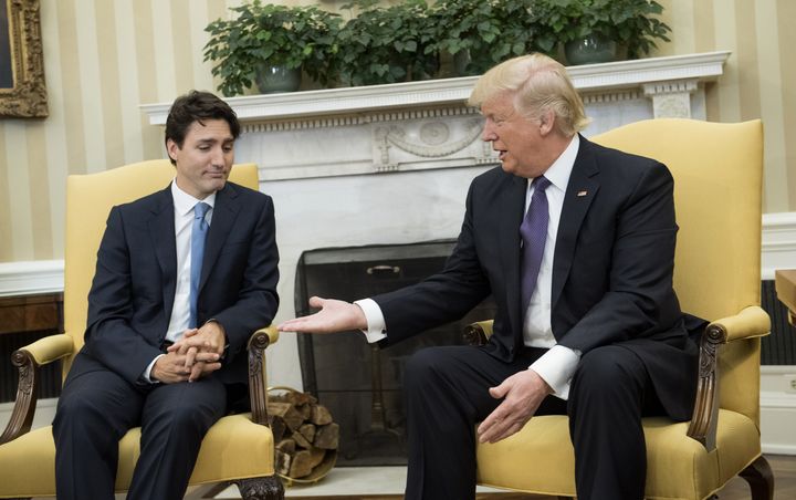 Donald Trump extends his hand to Justin Trudeau during a meeting in the Oval Office of the White House in Washington.
