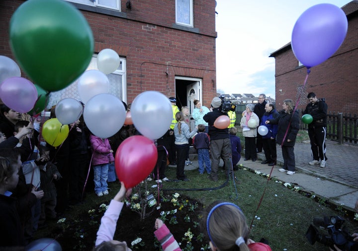 Karen Matthews talks on the microphone after planting flowers in her garden with local children at Moorside Road, Dewsbury Moor, West Yorkshire in 2008