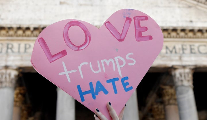 A person holds a heart-shaped sign during a rally against President Donald Trump in Rome on Jan. 21.