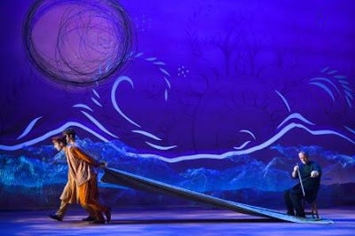 David Coulter (right) performing on a musical saw during the opening sequence of <strong><em>A Thousand Splendid Suns</em></s