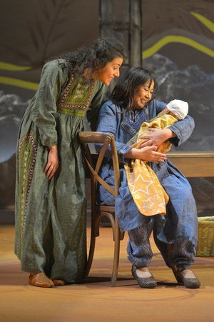 Laila (Nadine Malouf) and Mariam (Kate Rigg) tend to baby Azizah in a scene from <strong><em>A Thousand Splendid Suns</em></s