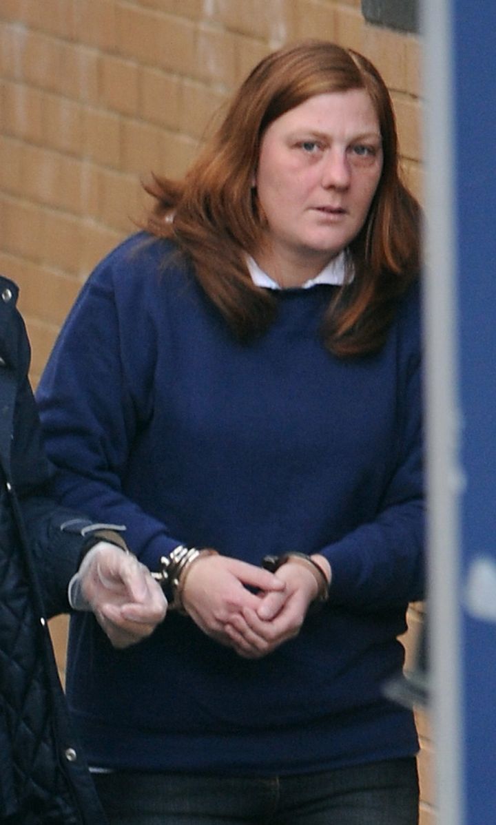 Karen Matthews is led from Dewsbury police station, before her court appearance in March 2008