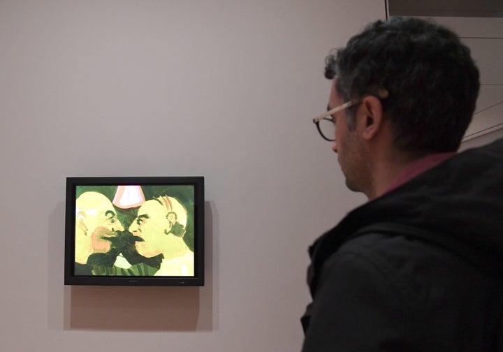 A man looks at artwork by Iranian artist Tala Madani 'The Chit Chat, 2007' at The Museum of Modern Art on February 3, 2017 in New York City. The famed New York art museum has joined the throng of protests against US President Donald Trump's travel ban by replacing Western art with pieces by Iranian, Iraqi and Sudanese-born artists. The Museum of Modern Art said the seven works by Sudanese painter Ibrahim el-Salahi, the late Iraqi-born architect Zaha Hadid and five Iranian-born artists replaced seven works by Picasso, Matisse and other Westerners.