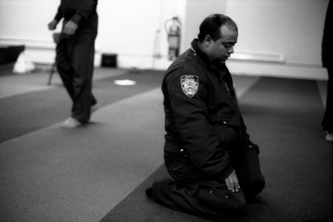 Robert Gerhardt, "NYPD Traffic Officer at Prayers, Park 51," Manhattan, New York, 2012.