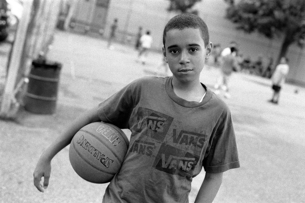 Robert Gerhardt, "Young Basketball Player in the Park before Friday Prayers," Brooklyn, New York, 2011.